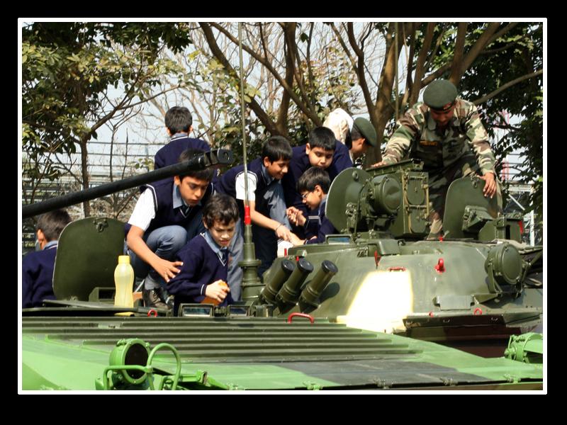 School students sees the army equipment.
